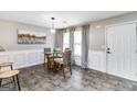 Bright dining room with a round glass table, pendant lighting, and neutral decor at 1147 Dunivin Dr, Jonesboro, GA 30238