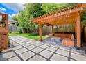 Inviting backyard featuring a wooden pergola with built-in seating and a stone patio at 496 Rankin Ne St, Atlanta, GA 30308