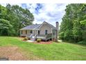 Spacious backyard showcasing a well-maintained lawn, mature trees, and a deck for outdoor enjoyment at 400 Kenny Ln, Temple, GA 30179