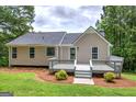 Expansive backyard features a wooden deck, lush lawn, and mature trees providing ample privacy at 400 Kenny Ln, Temple, GA 30179