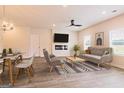 Inviting living room bathed in natural light, featuring sleek furniture, and seamlessly flowing into the dining area at 1662 Fuma Leaf Way # 308, Mcdonough, GA 30253