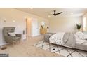 Serene main bedroom showcasing a cozy sitting area, plush carpet, and soothing neutral tones for relaxation at 1662 Fuma Leaf Way # 308, Mcdonough, GA 30253