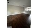 Open-concept living room boasts gleaming hardwood floors and a view of the bright, modern kitchen at 11313 Michelle Way, Hampton, GA 30228