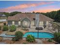 Private backyard oasis with a sparkling pool and beautifully landscaped patio area at 1422 New Holland Cir, Mcdonough, GA 30252
