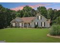 Inviting home with a well-maintained lawn and mature trees, perfect for suburban living at 1422 New Holland Cir, Mcdonough, GA 30252