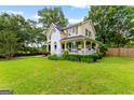 Lovely two-story house with a well-maintained yard and white picket fence at 135 Cherokee Pl, Fayetteville, GA 30215