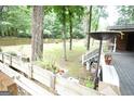 Lush backyard with deck, wooded landscape, and tiered planter boxes at 3010 Waters Sw Rd, Atlanta, GA 30354