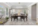 Bright dining room with stylish chandelier, large windows, and seating for six at 140 Canyons, Hampton, GA 30228