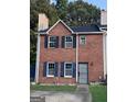Charming two-story brick home with a well-maintained front yard and a secure metal gate at 990 Hickory Bend Rd, Atlanta, GA 30349