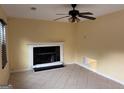 Bright living room featuring a ceiling fan, fireplace and tile flooring at 990 Hickory Bend Rd, Atlanta, GA 30349