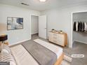 Serene staged bedroom with soft lighting, neutral tones, and a well-organized closet at 1480 D Ne Pine Log Rd # D, Conyers, GA 30012