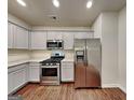 Modern kitchen featuring stainless steel appliances, granite countertops, and wooden floors at 3712 Upland Dr, Mcdonough, GA 30253