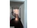 Inviting hallway with hardwood floors and decorative trim, leading to various rooms at 3750 Richmond Bnd, Lithonia, GA 30038