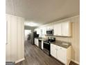 Updated kitchen with stainless steel appliances, granite countertops, and neutral-toned cabinets at 3403 Linda Dr, Lithia Springs, GA 30122