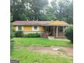 Charming single-story home with a welcoming front porch and a well-maintained lawn at 5420 Herndon Blvd, Morrow, GA 30260
