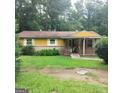Charming single-story home with a welcoming front porch and a well-maintained lawn at 5420 Herndon Blvd, Morrow, GA 30260