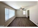 Bright living room featuring neutral walls, wood-look flooring, ceiling fan, and large picture windows at 2015 Boulderview Se Dr, Atlanta, GA 30316