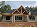 New construction showcases a covered back patio, featuring an open ceiling and several windows at 365 Spruill Bridge Road # 7 - Helmsley Park, Temple, GA 30179