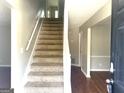 Inviting entryway with a staircase, hardwood floors, and neutral-colored walls at 755 Kilkenny Cir, Lithonia, GA 30058