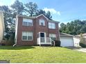 Charming brick two-story home with an attached garage and a well-maintained lawn at 755 Kilkenny Cir, Lithonia, GA 30058