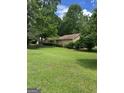 Traditional home set back from the street has mature trees enhancing its curb appeal at 8440 Winston Way, Jonesboro, GA 30236