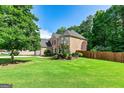 A large, well-maintained lawn and a view of the side of the brick house at 1605 Cascade Overlook, Peachtree City, GA 30269