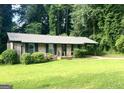 Charming brick home with mature landscaping and an attached carport at 341 Pineland Sw Rd, Mableton, GA 30126