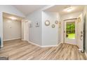 Inviting foyer with light gray walls, decorative mirrors, and luxury vinyl plank flooring at 107 Trisha Ln, Grantville, GA 30220