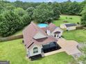 Expansive property with mature trees, swimming pool, and detached garage in a private setting at 250 Stallsworth Rd, Mcdonough, GA 30252