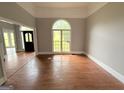 Sunlit living room with large windows and hardwood floors at 2325 Lochinver Sw Ln, Conyers, GA 30094