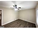 This bedroom is illuminated by a ceiling fan and showcases sleek, modern vinyl flooring at 4385 Midway Rd, Douglasville, GA 30134