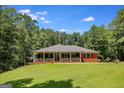 Well-maintained red brick home with a spacious front yard and a welcoming covered porch at 543 Wynn Rd, Mcdonough, GA 30252