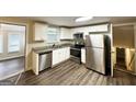 Modern kitchen featuring stainless steel appliances, white cabinets, granite counters, and an undermount sink at 5670 Bob White Ln, Douglasville, GA 30135