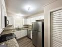 Modern kitchen with white cabinets, granite countertops, and stainless steel appliances at 2500 Brentwood Rd, Decatur, GA 30032