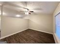 Spacious bedroom with ceiling fan, wood-look flooring, and neutral-colored walls for a serene atmosphere at 410 Tarragon Sw Way, Atlanta, GA 30331