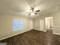 Inviting living room with wood-look flooring, natural light, and open access to other areas at 410 Tarragon Sw Way, Atlanta, GA 30331