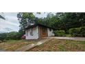 Property exterior showing painted brick, and a partial view of the lawn and driveway at 4916 Campbellton Sw Rd, South Fulton, GA 30331