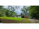Scenic exterior of home with deck and lush greenery, offering a serene, private setting at 4916 Campbellton Sw Rd, South Fulton, GA 30331