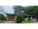 Inviting home featuring painted brick, wood siding, and well-manicured landscaping at 4916 Campbellton Sw Rd, South Fulton, GA 30331