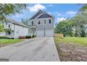 Beautiful two-story home features a long driveway and a freshly sodded yard at 583 Whitaker Nw St, Atlanta, GA 30318