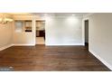 Open-concept living room featuring hardwood floors and views into the kitchen at 3153 Bellgreen Way, Decatur, GA 30032
