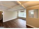 Bright living room featuring hardwood floors, large windows, and stylish coffered ceilings at 3153 Bellgreen Way, Decatur, GA 30032