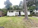 Charming single-story home featuring a freshly painted brick exterior and a well-manicured lawn at 2327 Scotty Cir, Decatur, GA 30032