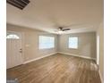 Well-lit living room featuring wood-look flooring, a ceiling fan, and bright windows at 2327 Scotty Cir, Decatur, GA 30032