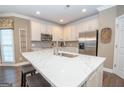 Bright kitchen featuring a quartz countertop island, stainless steel appliances, and white cabinetry at 220 Lavender Oasis, Peachtree City, GA 30269