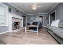 Inviting living room featuring a cozy brick fireplace, plush sofas, and stylish decor at 6391 Katherine St, Douglasville, GA 30134