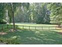 Large backyard, enclosed by a wood fence and backed by mature trees at 110 Heatherwood Dr, Fayetteville, GA 30215