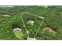 Aerial view of a secluded 5-acre lot with a stunning home nestled among lush greenery at 140 Olivia Ct, Fayetteville, GA 30215