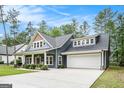 A well-manicured lawn and long driveway lead up to the pleasing facade of this home at 9148 Tarnwood Dr, Villa Rica, GA 30180