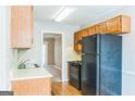 Functional kitchen equipped with wood cabinets and essential appliances at 1099 Westfield Se Trce, Smyrna, GA 30082